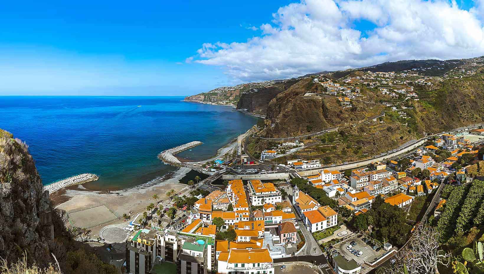 A coastal town with red-roofed buildings and cliffs overlooking the blue ocean | MSC Cruises A coastal town with red-roofed buildings and cliffs overlooking the blue ocean | MSC Cruises