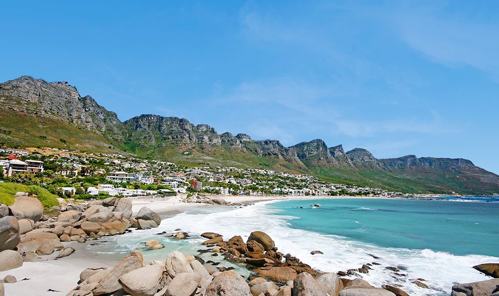 Scenic coastal view of Camps Bay with turquoise waters and the Twelve Apostles mountain range | MSC Cruises Scenic coastal view of Camps Bay with turquoise waters and the Twelve Apostles mountain range | MSC Cruises