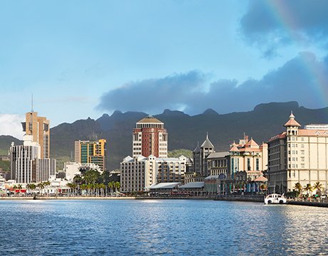 Port Louis waterfront with mountain backdrop and vibrant cityscape | MSC Cruises Port Louis waterfront with mountain backdrop and vibrant cityscape | MSC Cruises