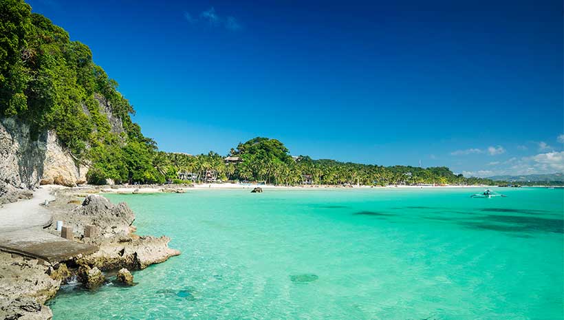 Tropical beach with turquoise waters and lush palm trees, perfect for a cruise destination | MSC Cruises Tropical beach with turquoise waters and lush palm trees, perfect for a cruise destination | MSC Cruises