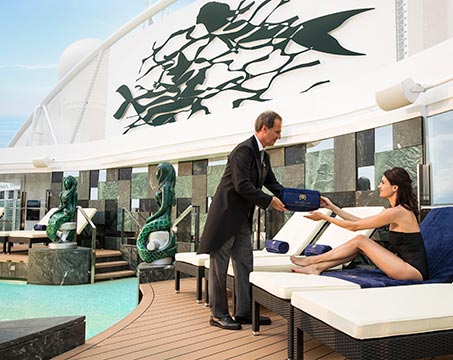 A guest enjoying poolside service on an MSC cruise ship deck | MSC Cruises