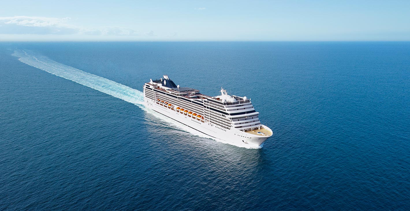 A luxury MSC cruise ship sailing through open blue waters | MSC Cruises