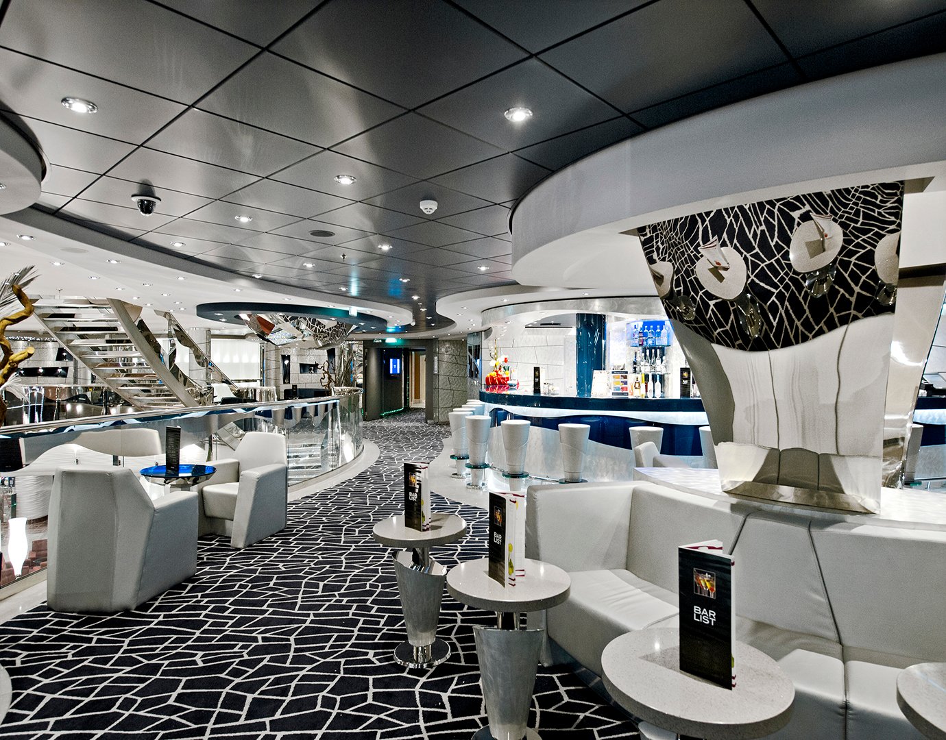 Modern lounge with sleek design, bar, and seating on an MSC cruise ship | MSC Cruises Modern lounge with sleek design, bar, and seating on an MSC cruise ship | MSC Cruises