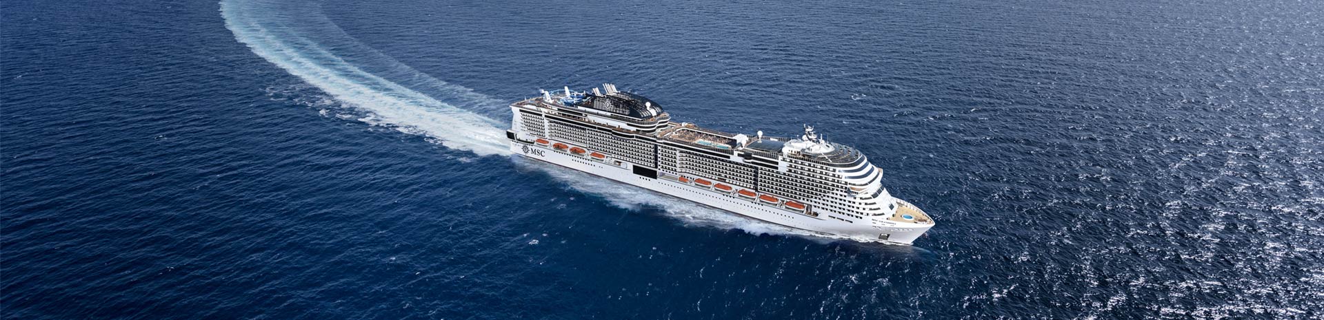 An MSC cruise ship gliding through open blue waters | MSC Cruises An MSC cruise ship gliding through open blue waters | MSC Cruises