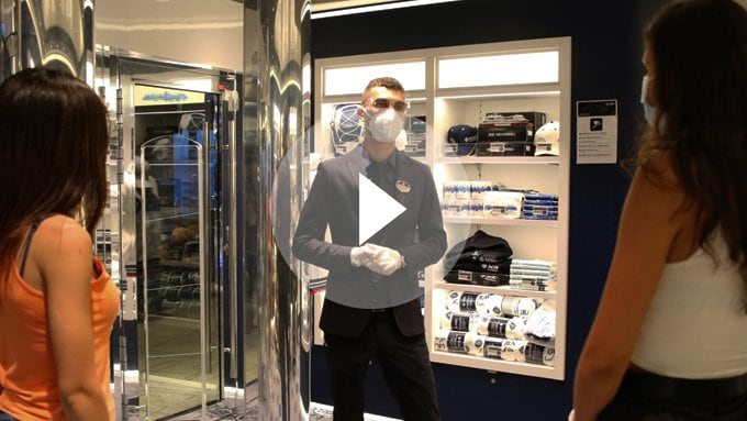Crew member assisting guests in a merchandise shop aboard a cruise ship | MSC Cruises Crew member assisting guests in a merchandise shop aboard a cruise ship | MSC Cruises