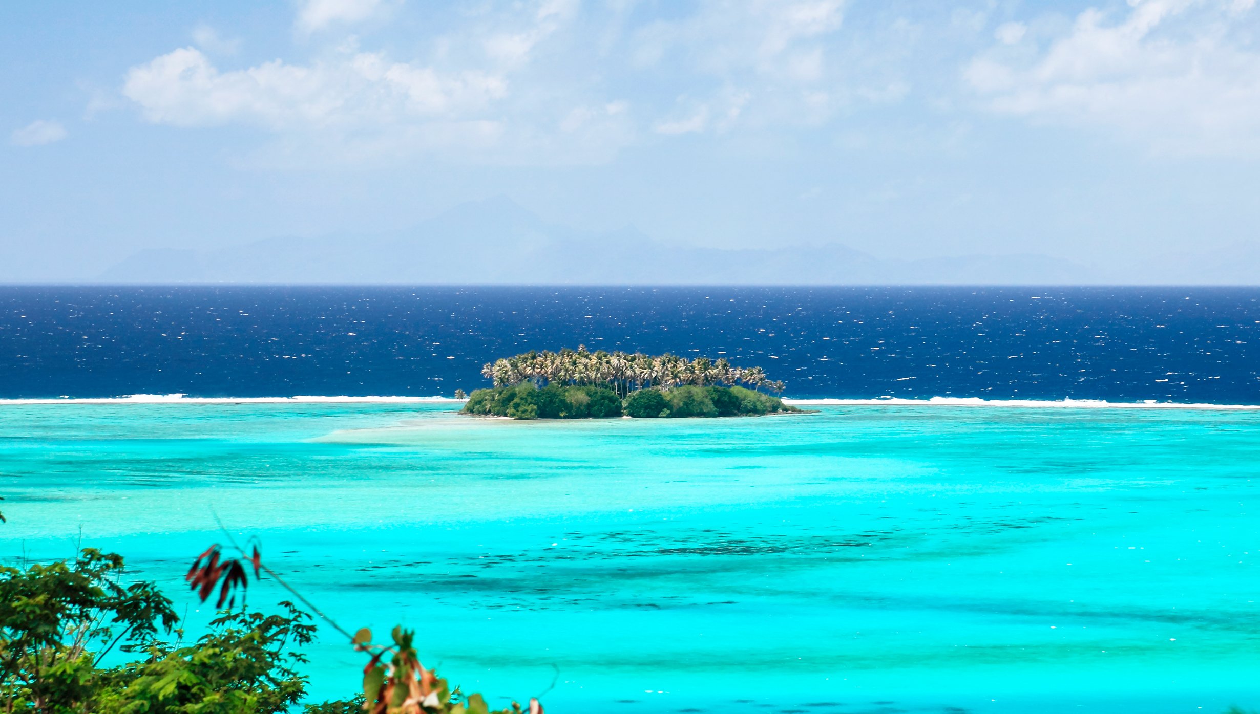 A small tropical island surrounded by turquoise waters and a deep blue ocean | MSC Cruises