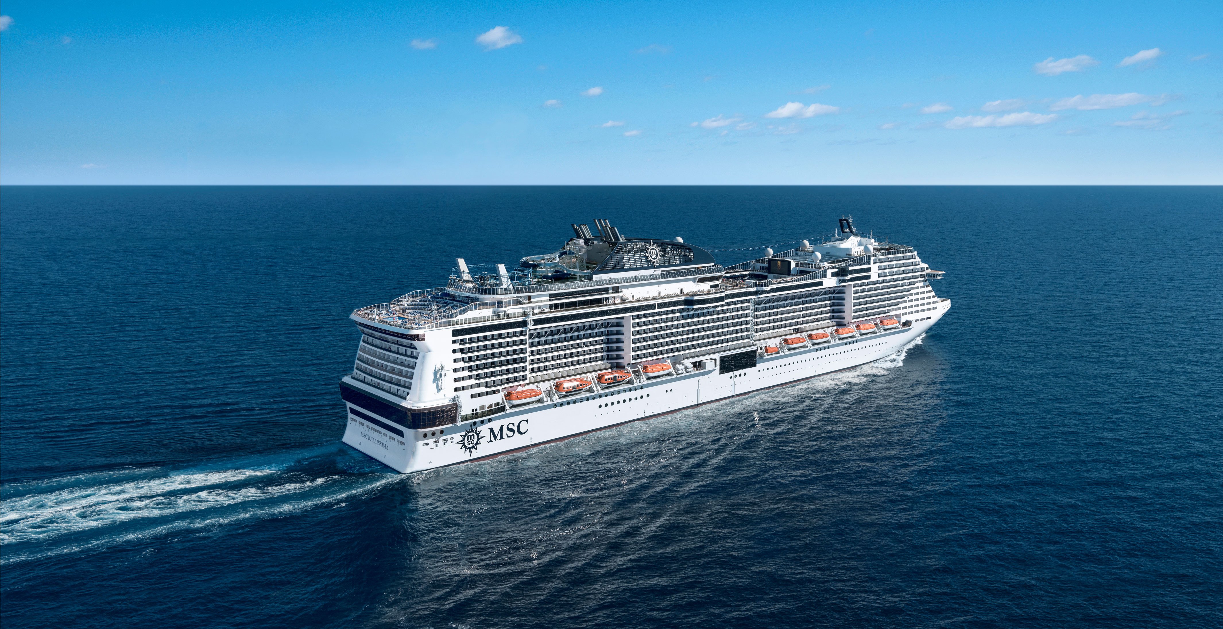 An MSC cruise ship sailing on calm blue waters under a clear sky | MSC Cruises