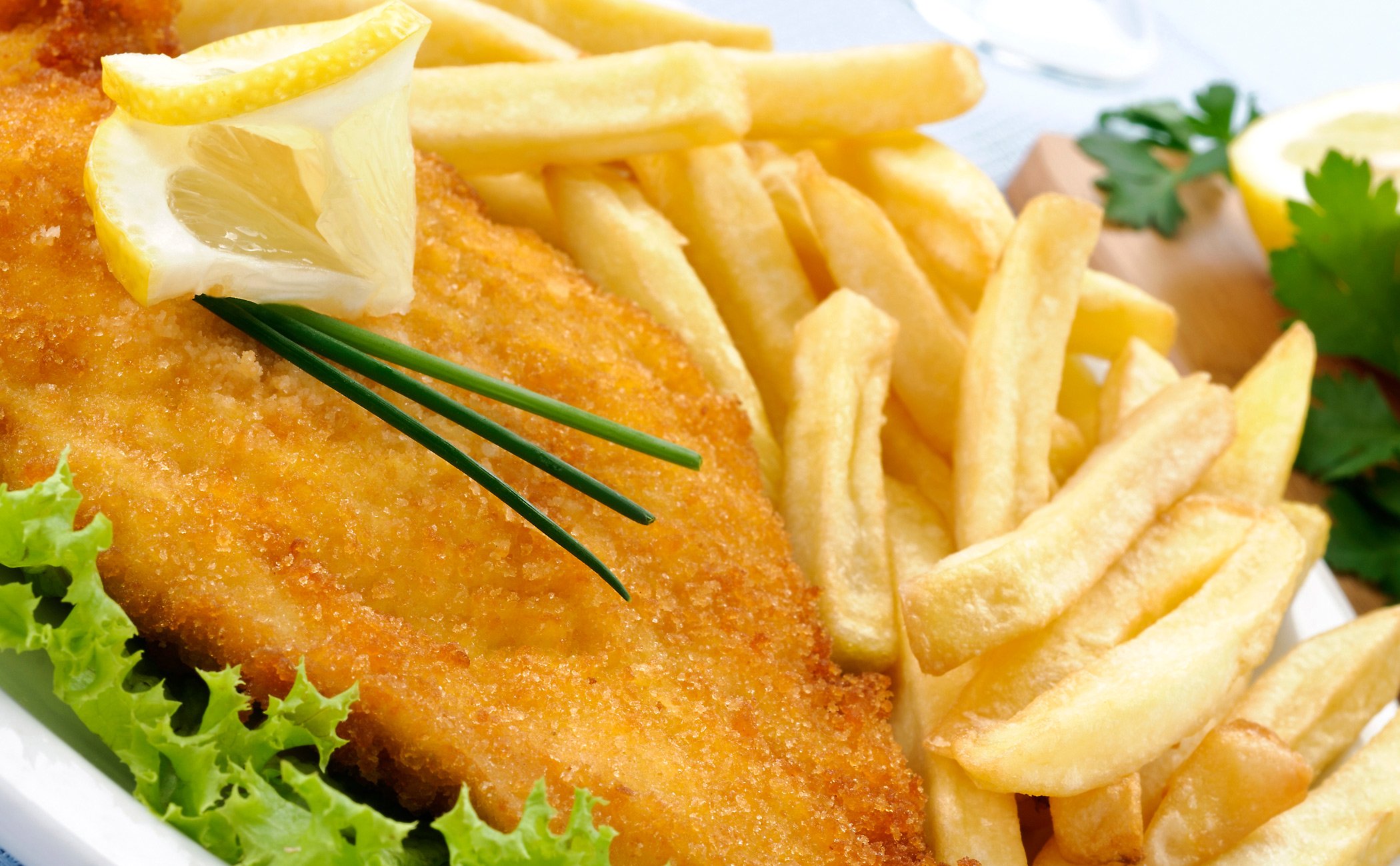 Crispy fish fillet with golden fries and fresh garnish served onboard | MSC Cruises