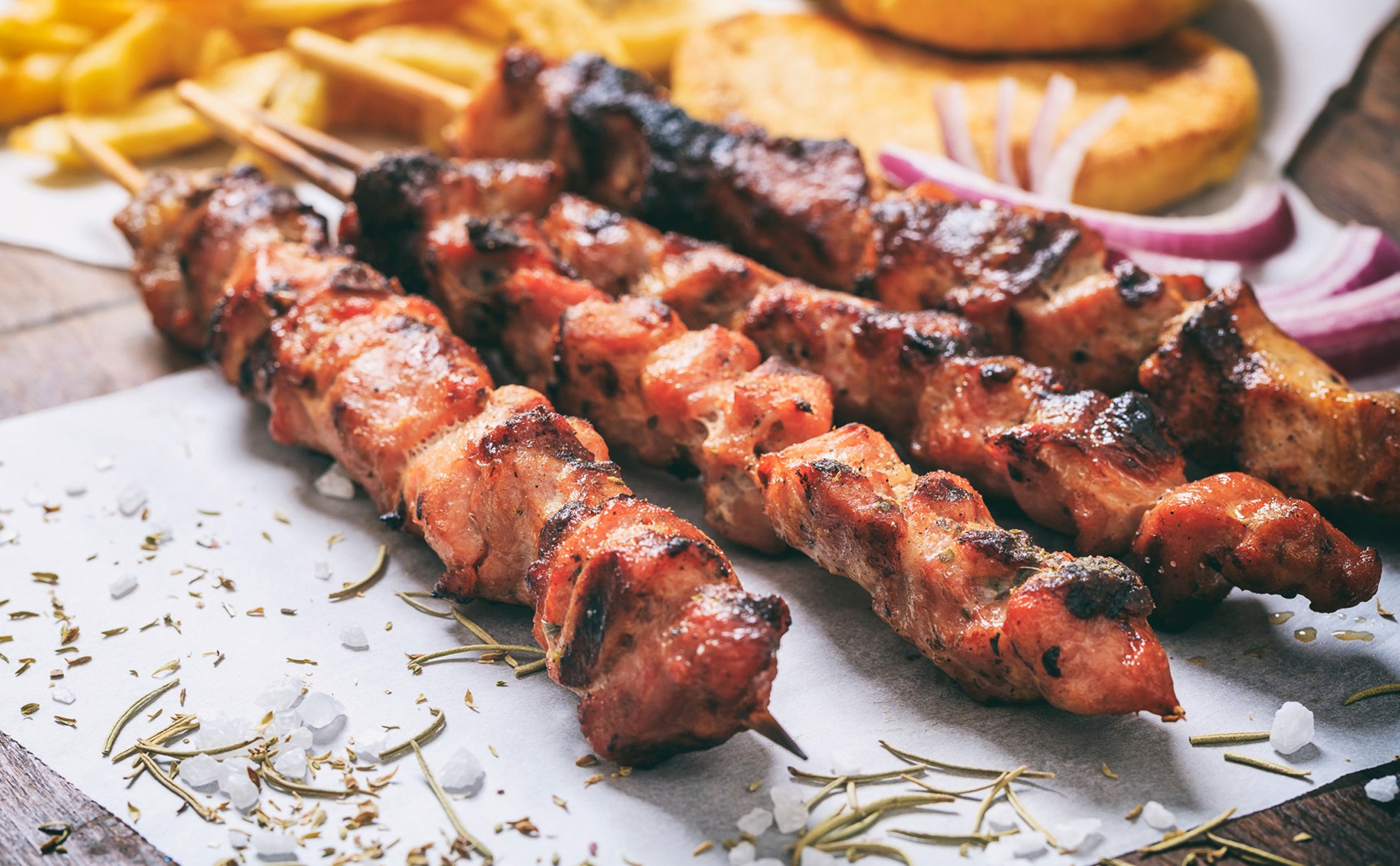 Grilled meat skewers served with sides, showcasing onboard dining options | MSC Cruises