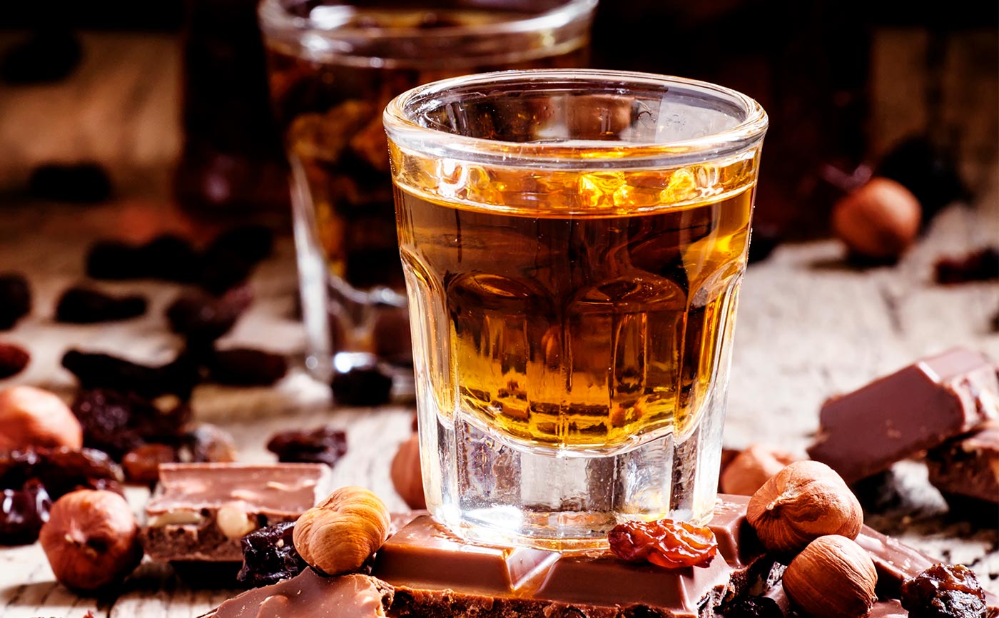 A glass of whiskey paired with chocolate and hazelnuts, evoking a luxurious cruise experience | MSC Cruises