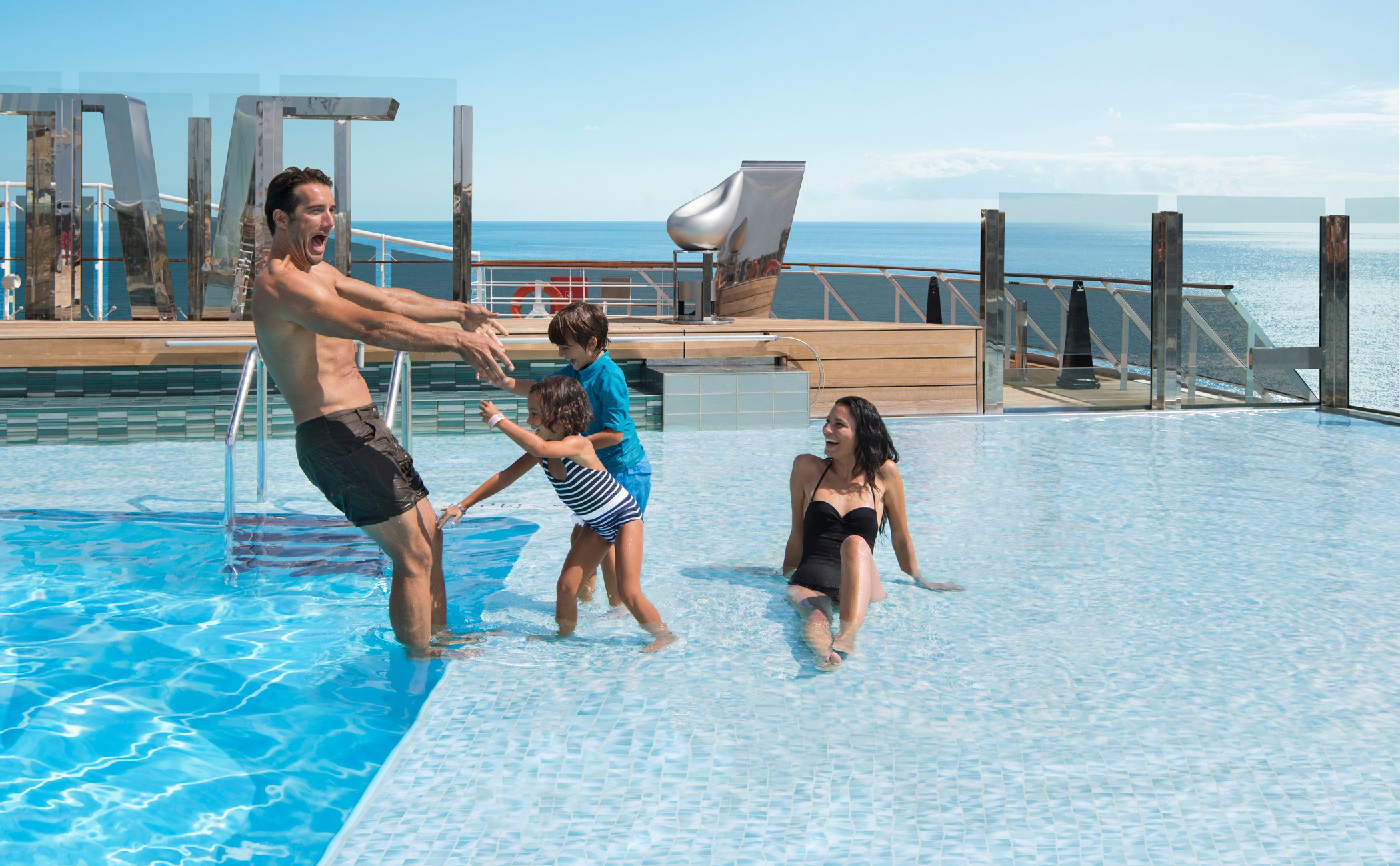Family enjoying a pool on a cruise ship with ocean views | MSC Cruises