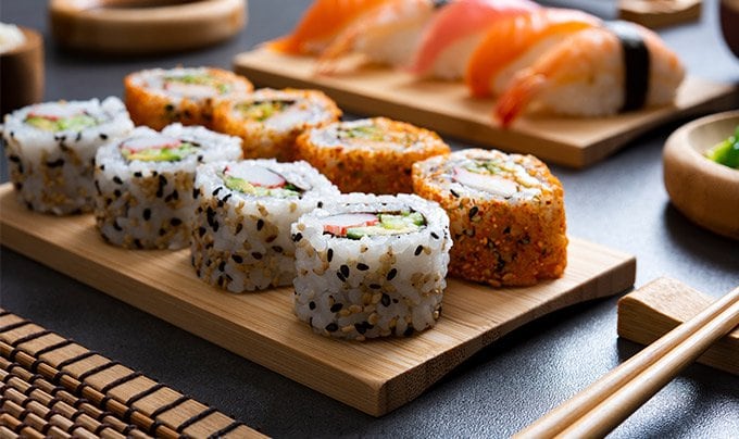 Assorted sushi rolls and nigiri served on wooden platters | MSC Cruises Assorted sushi rolls and nigiri served on wooden platters | MSC Cruises