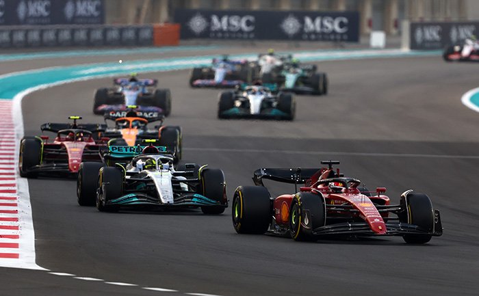 Formula 1 cars racing on a track with MSC branding in the background | MSC Cruises