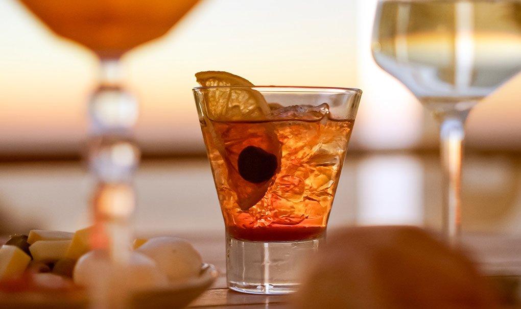 A refreshing cocktail with sunset views onboard | MSC Cruises