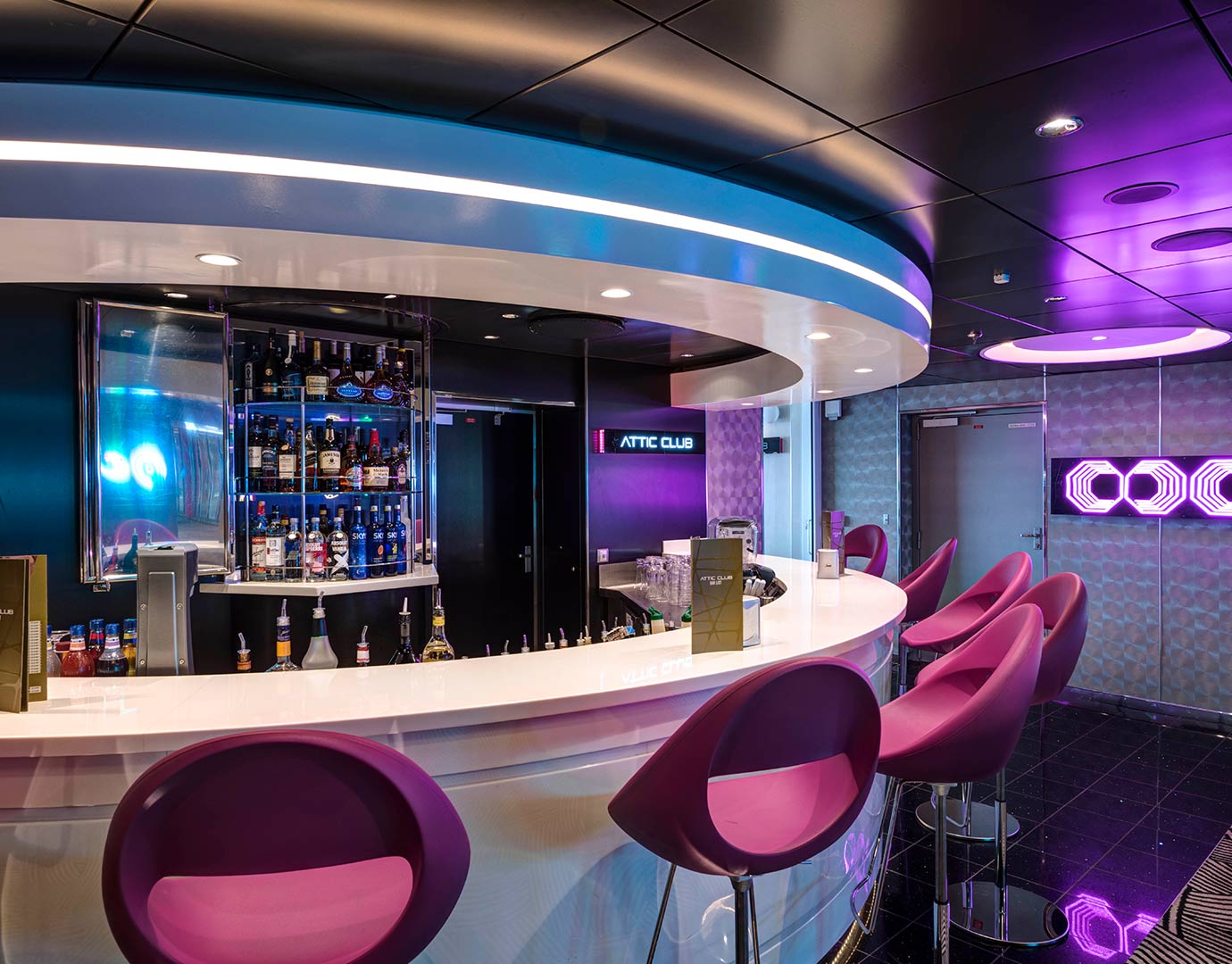 Modern bar with purple chairs and illuminated decor onboard an MSC cruise ship | MSC Cruises Modern bar with purple chairs and illuminated decor onboard an MSC cruise ship | MSC Cruises